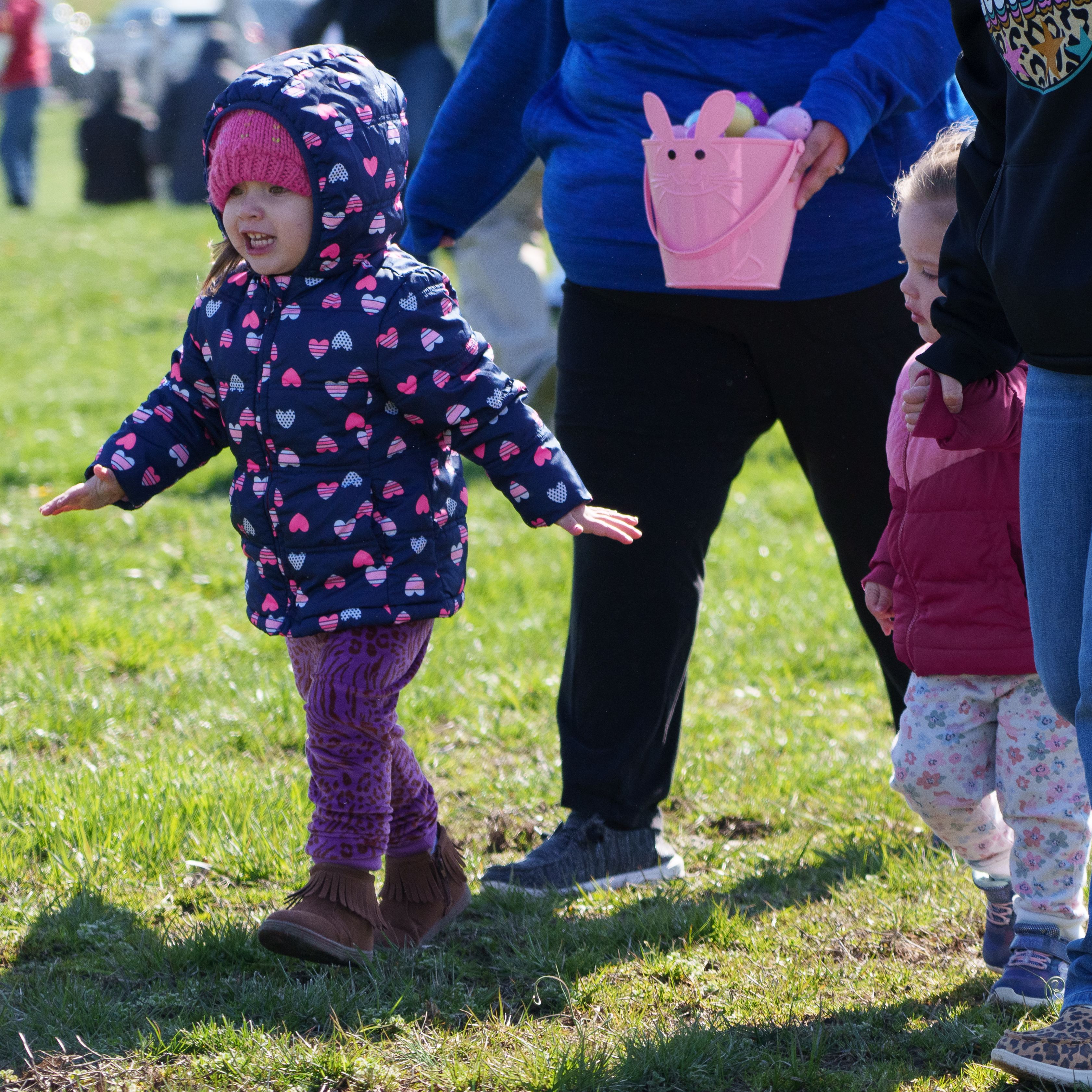 Photo of an excited young girl looking across the field