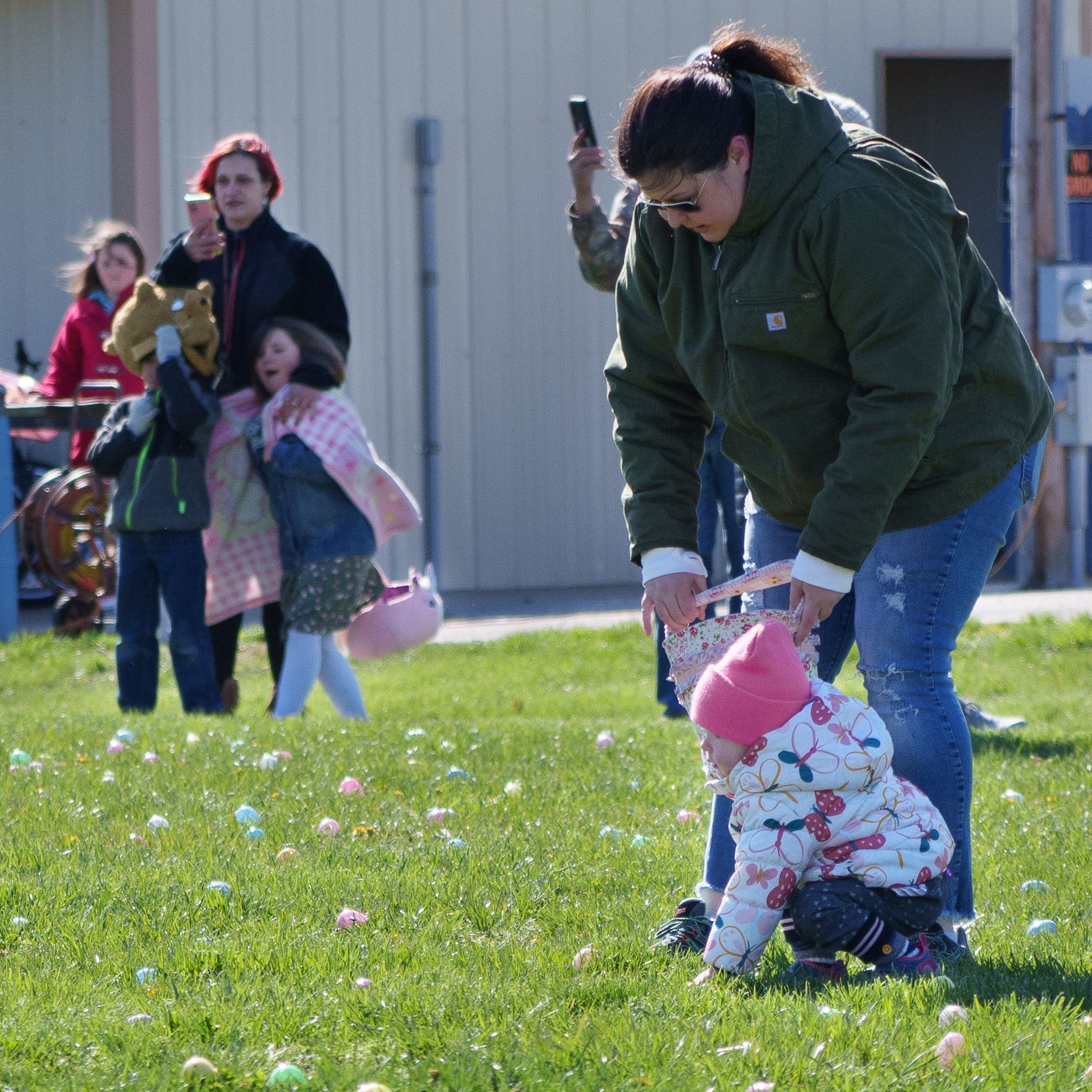 Photo of a child choosing an egg, surrounded by dozens of eggs