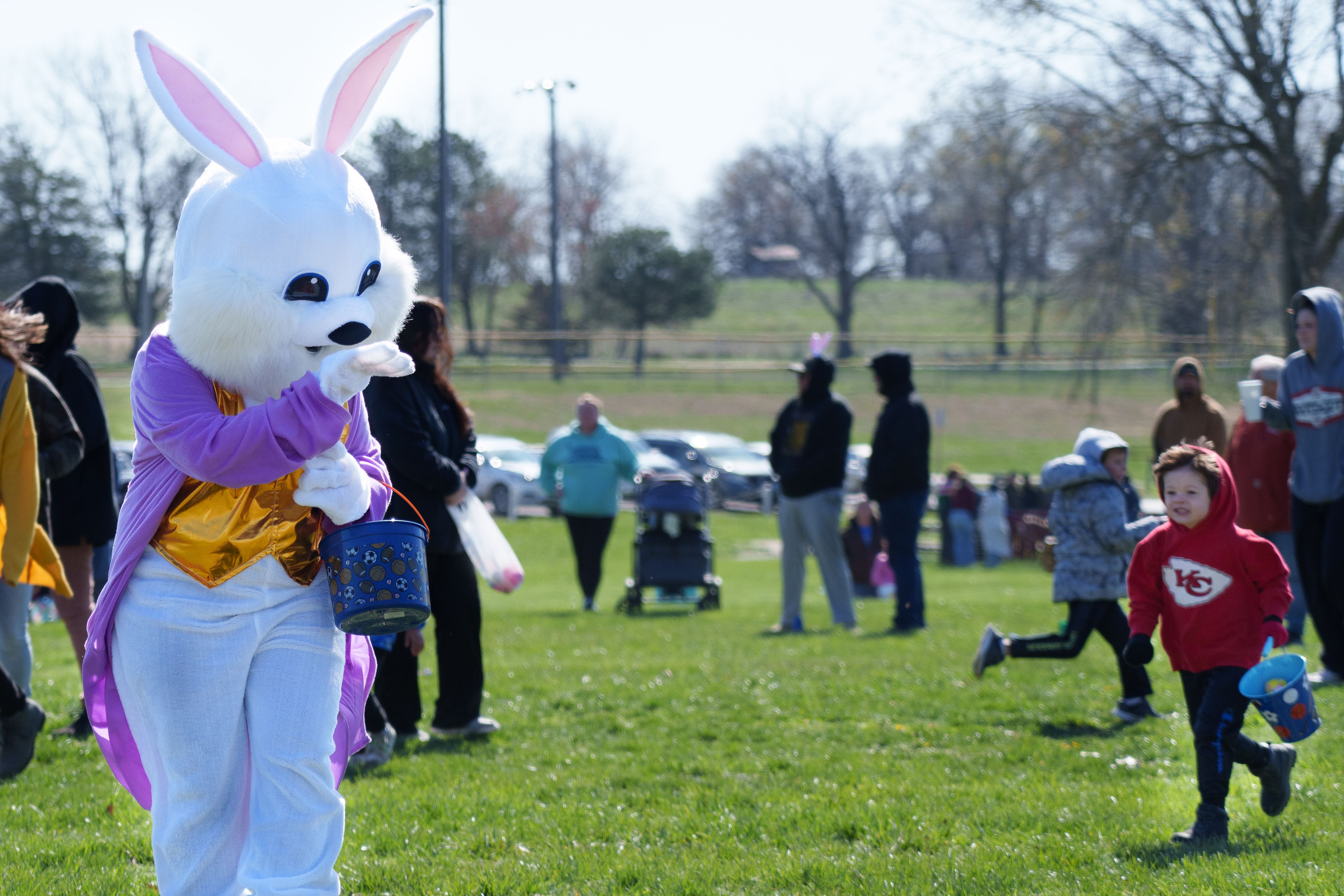 Photo of a child sprinting towards an easter bunny mascot