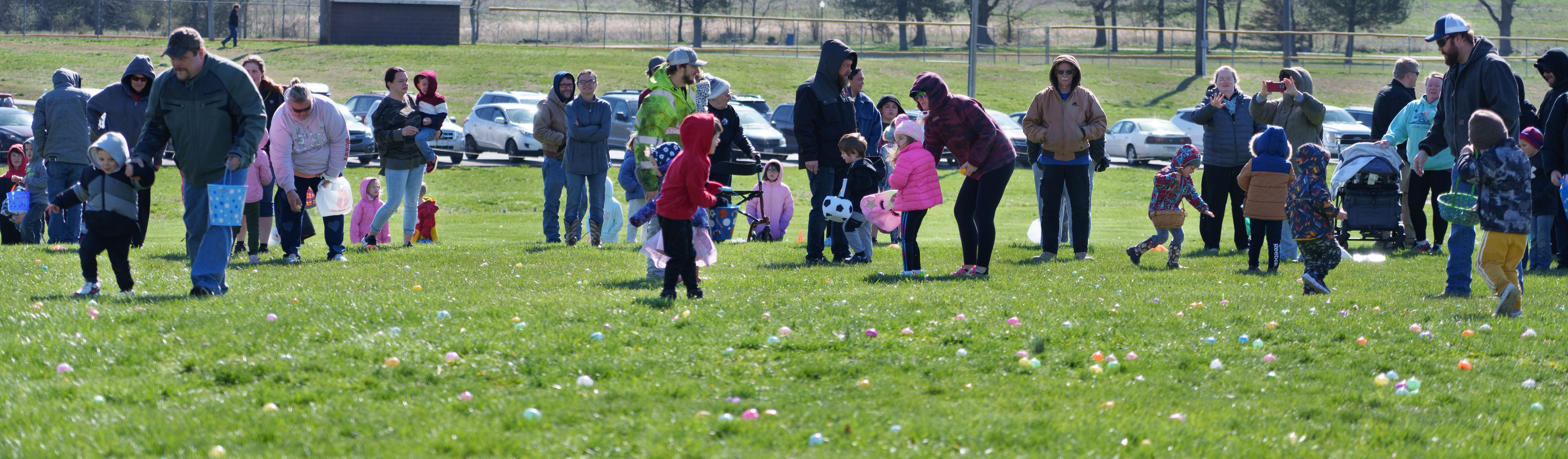 Photo of parents accompanying young children onto the field