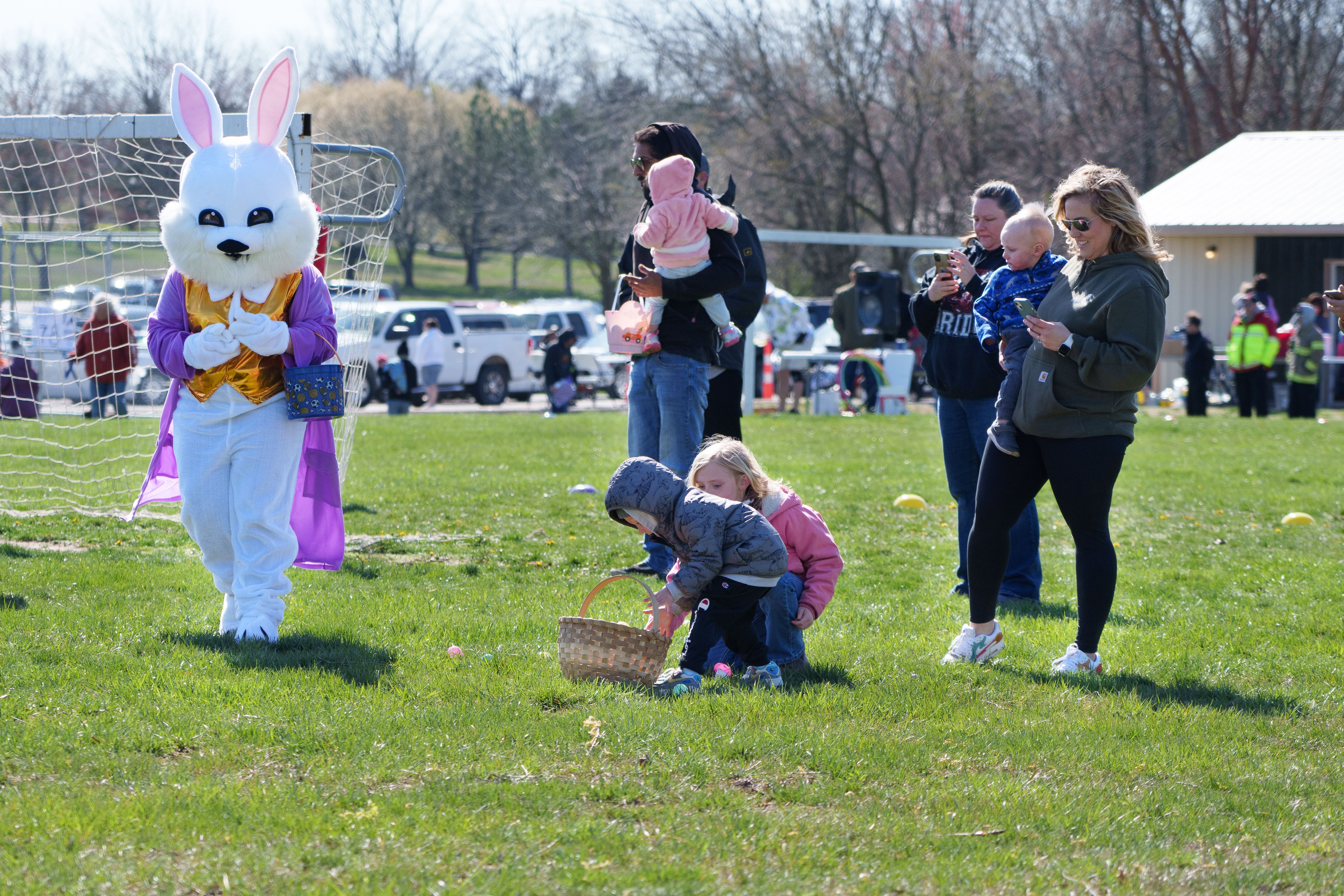 Photo of a child picking up a plastic egg